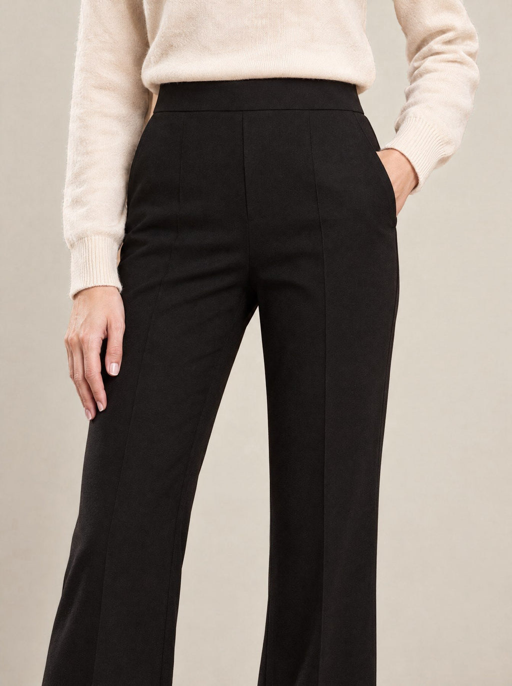 Black Flare Trousers, detail of the high waist and pressed crease