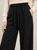 Black Wide-Leg Trousers, detail of the elasticated waist and drawstring